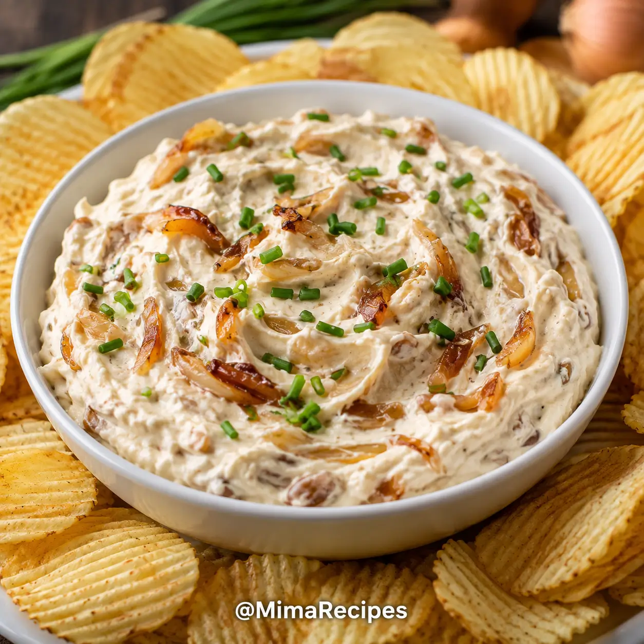 Creamy caramelized onion dip served with potato chips